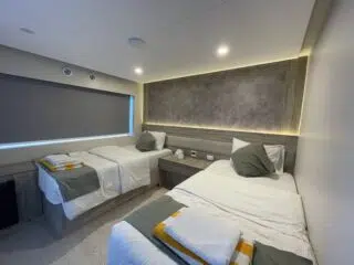 Nowoczesny pokój hotelowy z dwoma łóżkami - idealny wypoczynek po szkoleniu kite lub wyjeździe kitesurfingowym z KiteAway.