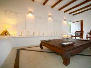 Przytulny, jasny salon z białą ławą i drewnem - idealny na relaks po kite camp lub wyjazdy kitesurfingowe z KiteAway.