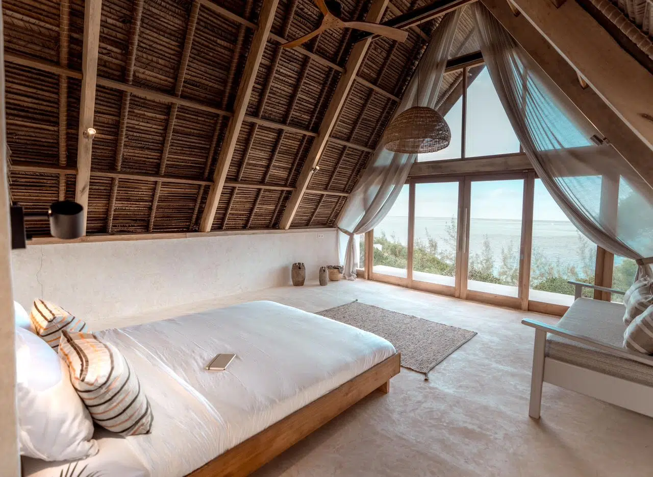 Przytulna sypialnia z dużymi oknami na oceanie, idealna na relaks po kursie kitesurfingu z KiteAway lub intensywnym obozie kitesurfingowym.