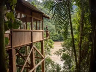 Drewniany domek na palach w tropikalnym lesie - idealne miejsce na relaks i planowanie wyjazdu kitesurfingowego z KiteAway.